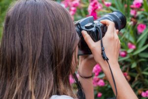 Lady taking pictures of flowers